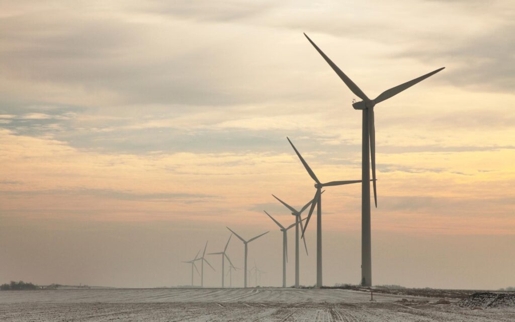 Ariscu’s guide to air quality management: Wind turbines on a dusty horizon representing proactive compliance with the National Environmental Management Air Quality Act.