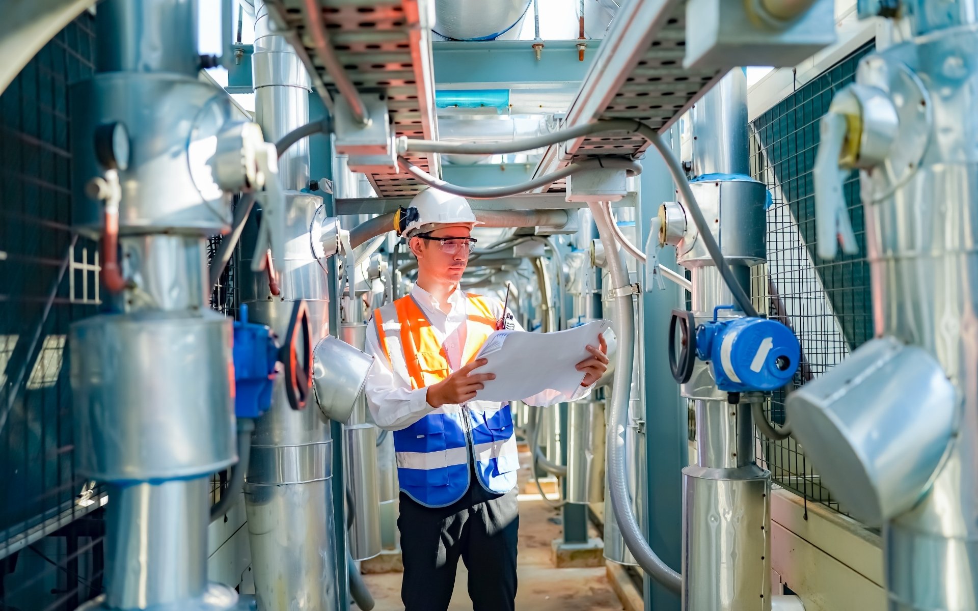 Safety auditor reviewing an OHS legal compliance checklist with a site manager in a facility